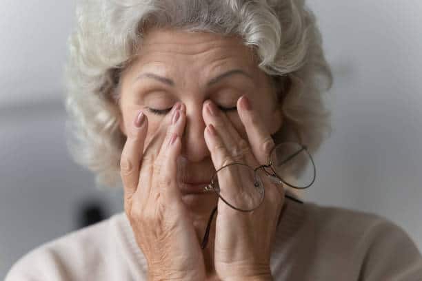 Middle age woman suffering from dry eyes