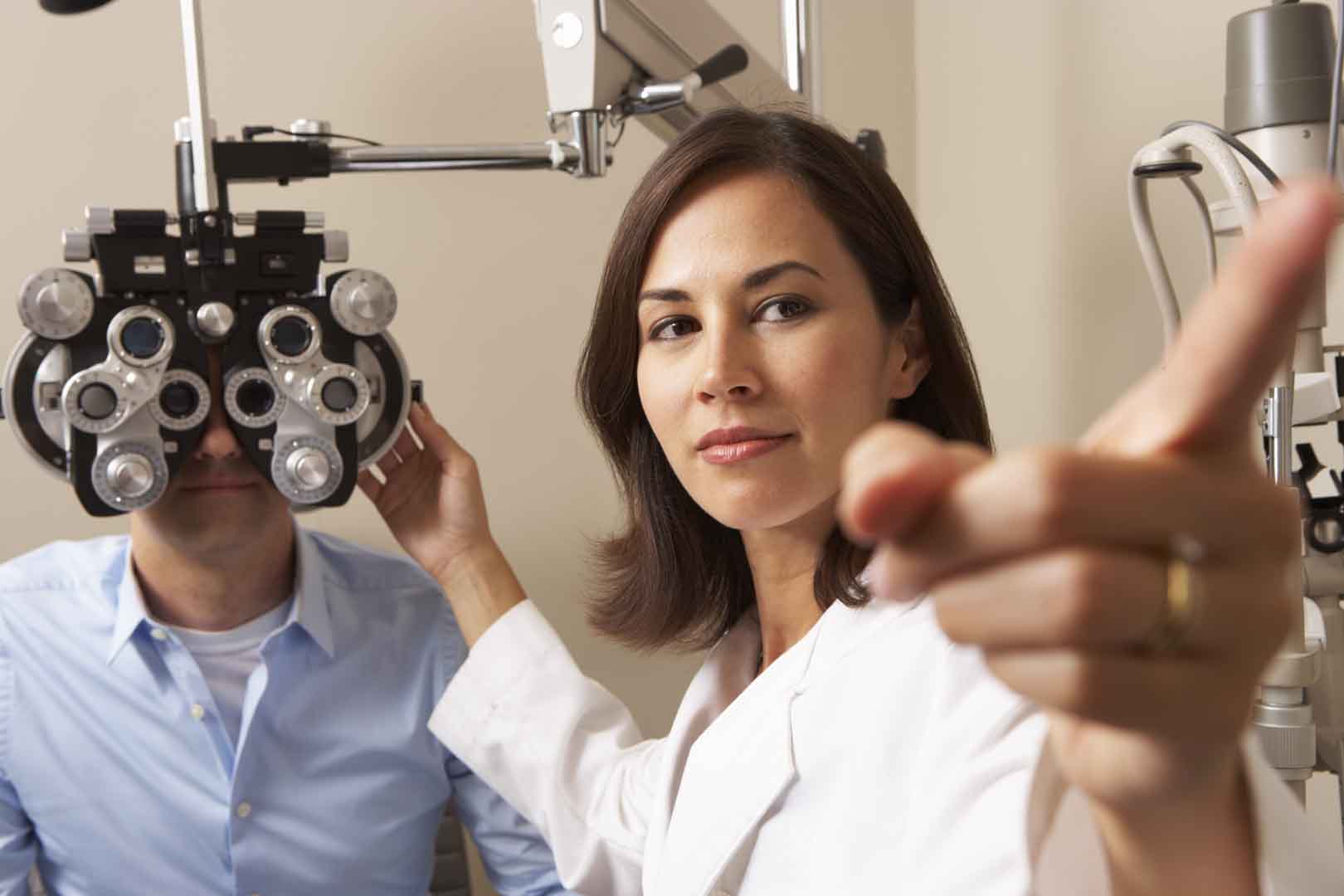Female optometrist giving an eye test